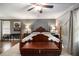 Bedroom with dark gray accent wall, a large bed, wood floors and carpet and a ceiling fan at 4715 Howard Dr, Powder Springs, GA 30127