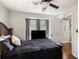 Bedroom with dark wood bed frame, and a large window with curtains for privacy at 4715 Howard Dr, Powder Springs, GA 30127