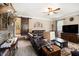 Comfortable living room with brown leather furniture, brick accent wall, hardwood floors, and ceiling fan at 4715 Howard Dr, Powder Springs, GA 30127