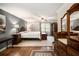 Serene main bedroom with hardwood floors, a seating area, light gray walls, a ceiling fan, and a large window at 4715 Howard Dr, Powder Springs, GA 30127