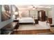 Main bedroom suite with light gray walls, wood flooring, ceiling fan, and a large window at 4715 Howard Dr, Powder Springs, GA 30127
