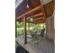 Inviting covered patio with wood ceiling, string lights, comfortable seating, and stylish outdoor rug at 4715 Howard Dr, Powder Springs, GA 30127