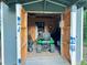 Open shed with lawn equipment and storage, perfect for maintaining a well-kept lawn and garden at 4715 Howard Dr, Powder Springs, GA 30127