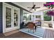 Inviting back porch with wicker furniture, ceiling fan, outdoor heater and colorful flowers at 144 Park Dr, Decatur, GA 30030