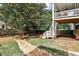 Well-maintained backyard featuring a stone drainage, stairs to a second story deck, and green grass at 144 Park Dr, Decatur, GA 30030