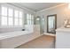 Luxurious bathroom featuring a soaking tub, glass-enclosed shower, and elegant fixtures at 144 Park Dr, Decatur, GA 30030
