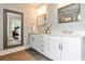 Modern bathroom featuring double vanity, decorative mirrors, and stylish lighting at 144 Park Dr, Decatur, GA 30030