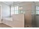 Contemporary bathroom with a glass shower, soaking tub, and elegant tile work at 144 Park Dr, Decatur, GA 30030