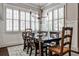 Elegant dining room with chandelier, wainscoting, plantation shutters, and a wooden dining table at 144 Park Dr, Decatur, GA 30030