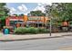 Universal Joint featuring a rustic exterior, outdoor seating areas, and lush landscaping at 144 Park Dr, Decatur, GA 30030