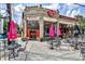 Mojo Pizza Pub exterior with outdoor seating, vintage brickwork, and bright pink umbrellas at 144 Park Dr, Decatur, GA 30030