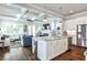 Open-concept living room and kitchen feature a granite island, stainless appliances, and coffered ceiling at 144 Park Dr, Decatur, GA 30030