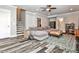 Stylish basement living room with gray plank flooring, a plush sofa, a staircase, and an area rug at 144 Park Dr, Decatur, GA 30030