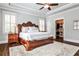 Spacious main bedroom with tray ceilings, a king bed, hardwood floors, and a walk-in closet at 144 Park Dr, Decatur, GA 30030