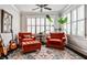 Cozy sitting room with large window, plantation shutters, guitars, and comfortable seating arrangement at 144 Park Dr, Decatur, GA 30030