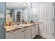 Bright bathroom featuring a double sink vanity, a large mirror with lighting, and a shower with a sliding glass door at 2505 Rockmart Rd, Villa Rica, GA 30180