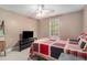 Inviting bedroom with natural light, a ceiling fan, and a vibrant quilt at 2505 Rockmart Rd, Villa Rica, GA 30180