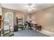 Bedroom featuring hardwood floors, a ceiling fan, and a large window at 2505 Rockmart Rd, Villa Rica, GA 30180