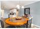 Cozy dining nook with wood floors, a unique round table, and ample natural light at 2505 Rockmart Rd, Villa Rica, GA 30180