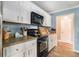 Bright kitchen with stainless steel appliances, white cabinets and contrasting counter tops at 2505 Rockmart Rd, Villa Rica, GA 30180