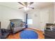 Cozy bedroom with a crib, overhead fan, hardwood flooring, and natural light at 2816 Pine Meadow Dr, Marietta, GA 30066
