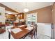 Open-concept dining area featuring a charming, wood dining table and a view into the kitchen at 2816 Pine Meadow Dr, Marietta, GA 30066