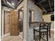 Basement bar area with counter seating and storage next to the staircase and two interior doors at 305 Spindle Ct, Sandy Springs, GA 30350
