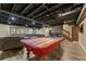 Recreational basement space featuring a pool table with an American flag cover and a comfortable sofa at 305 Spindle Ct, Sandy Springs, GA 30350