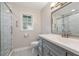Renovated bathroom with walk-in shower, stylish vanity, and patterned tile flooring at 305 Spindle Ct, Sandy Springs, GA 30350