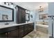 Bathroom with double vanity, dark cabinets, and a soaking tub at 305 Spindle Ct, Sandy Springs, GA 30350