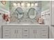 Stylish bathroom featuring double vanity, floral wallpaper, and elegant fixtures at 305 Spindle Ct, Sandy Springs, GA 30350