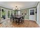 Light-filled dining room with hardwood floors, chandelier, and French doors to the backyard at 305 Spindle Ct, Sandy Springs, GA 30350