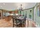 Dining room with hardwood floors, a view of the kitchen, and large windows overlooking the backyard at 305 Spindle Ct, Sandy Springs, GA 30350