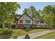 Charming Tudor-style home with a well-manicured front yard and a red front door at 305 Spindle Ct, Sandy Springs, GA 30350