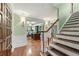 Elegant foyer featuring hardwood floors, stairs, and wainscoting with an open view to the living area at 305 Spindle Ct, Sandy Springs, GA 30350
