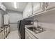 Functional laundry room with storage cabinets, sink, and laundry appliances at 305 Spindle Ct, Sandy Springs, GA 30350