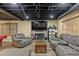 Cozy living room featuring comfortable sofas, brick fireplace, and a mounted flat screen television at 305 Spindle Ct, Sandy Springs, GA 30350