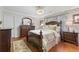 Cozy main bedroom with hardwood floors, crown molding, and elegant furnishings at 305 Spindle Ct, Sandy Springs, GA 30350