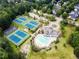 Aerial view of the neighborhood amenities showcasing the community pool, tennis courts, playground and surrounding greenery at 790 Riverwood Pass, Dallas, GA 30157
