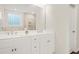 Bright bathroom featuring double vanity with white cabinets, chrome fixtures, and a large mirror at 790 Riverwood Pass, Dallas, GA 30157