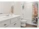 Charming bathroom with decorative shower curtain, white vanity, and wood-look flooring at 790 Riverwood Pass, Dallas, GA 30157