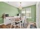 Dining room with modern light fixture, windows, and seating for six at 790 Riverwood Pass, Dallas, GA 30157