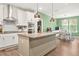 Modern kitchen with granite countertops, an island, stainless steel appliances, and stylish pendant lighting at 790 Riverwood Pass, Dallas, GA 30157