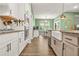 Spacious kitchen featuring granite countertops, white cabinetry, stainless steel appliances, and hardwood floors at 790 Riverwood Pass, Dallas, GA 30157