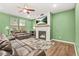 Inviting living room features a fireplace, ceiling fan, and plenty of natural light at 790 Riverwood Pass, Dallas, GA 30157