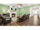 Comfortable living room with hardwood floors, a fireplace, a ceiling fan, and ample seating at 790 Riverwood Pass, Dallas, GA 30157