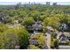 Expansive aerial view of a neighborhood featuring mature trees and traditional homes with a city skyline in the background at 1195 Oglethorpe Ne Ave, Atlanta, GA 30319