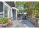 A back porch with gray wood and a dining area with outside seating, surrounded by a wood fence and trees at 1195 Oglethorpe Ne Ave, Atlanta, GA 30319