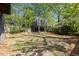 Large backyard featuring green grass and a charming wooden treehouse at 1195 Oglethorpe Ne Ave, Atlanta, GA 30319