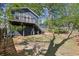 Spacious backyard with a deck, stairs, and ample green space surrounded by mature trees at 1195 Oglethorpe Ne Ave, Atlanta, GA 30319